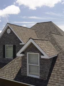 Multiple-elevation roof with newly installed asphalt shingles