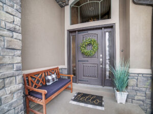 Beautiful home entrance with gray entry doors and windows above and on either side